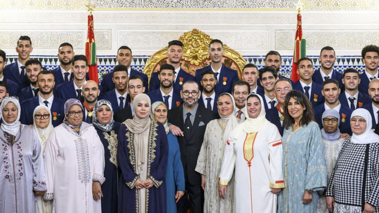 Morocco's King Mohammed VI (C) poses with the country's national football team players. Credit: AFP