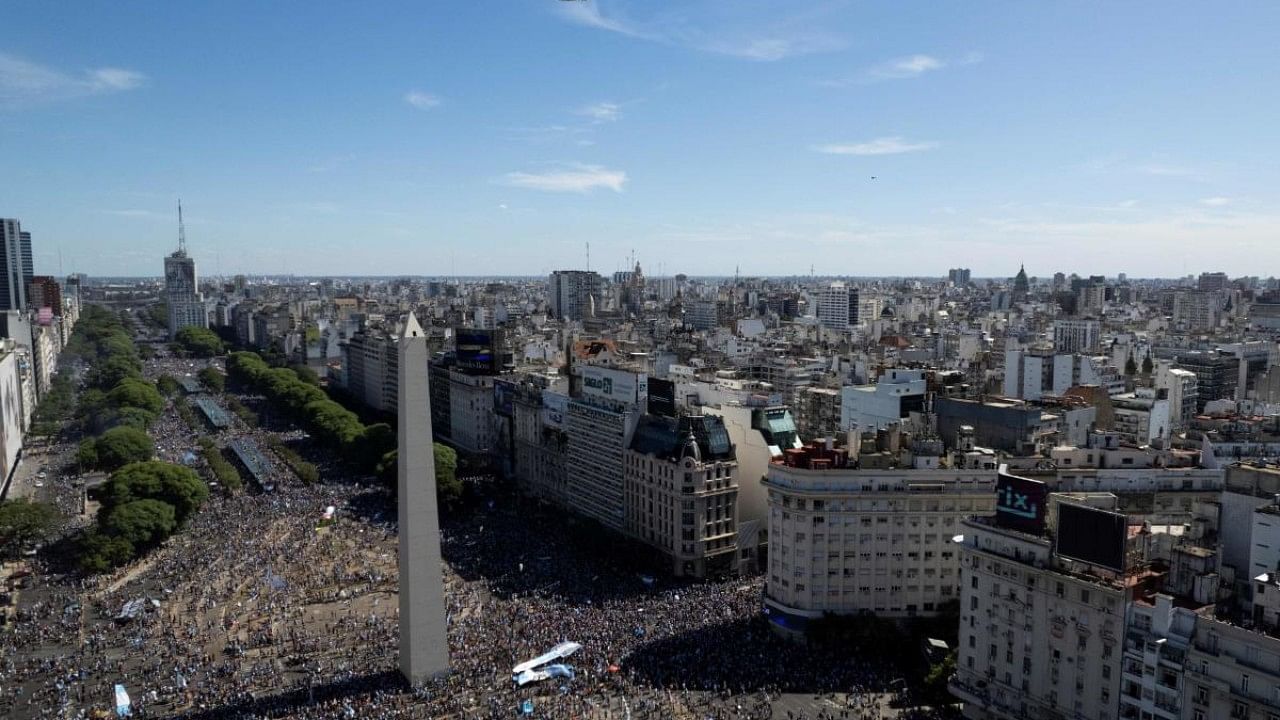 Aerial view of fans of Argentina waiting for the bus with Argentina's players to pass through the Obelisk to celebrate after winning the Qatar 2022 World Cup tournament in Buenos Aires. Credit: AFP Photo