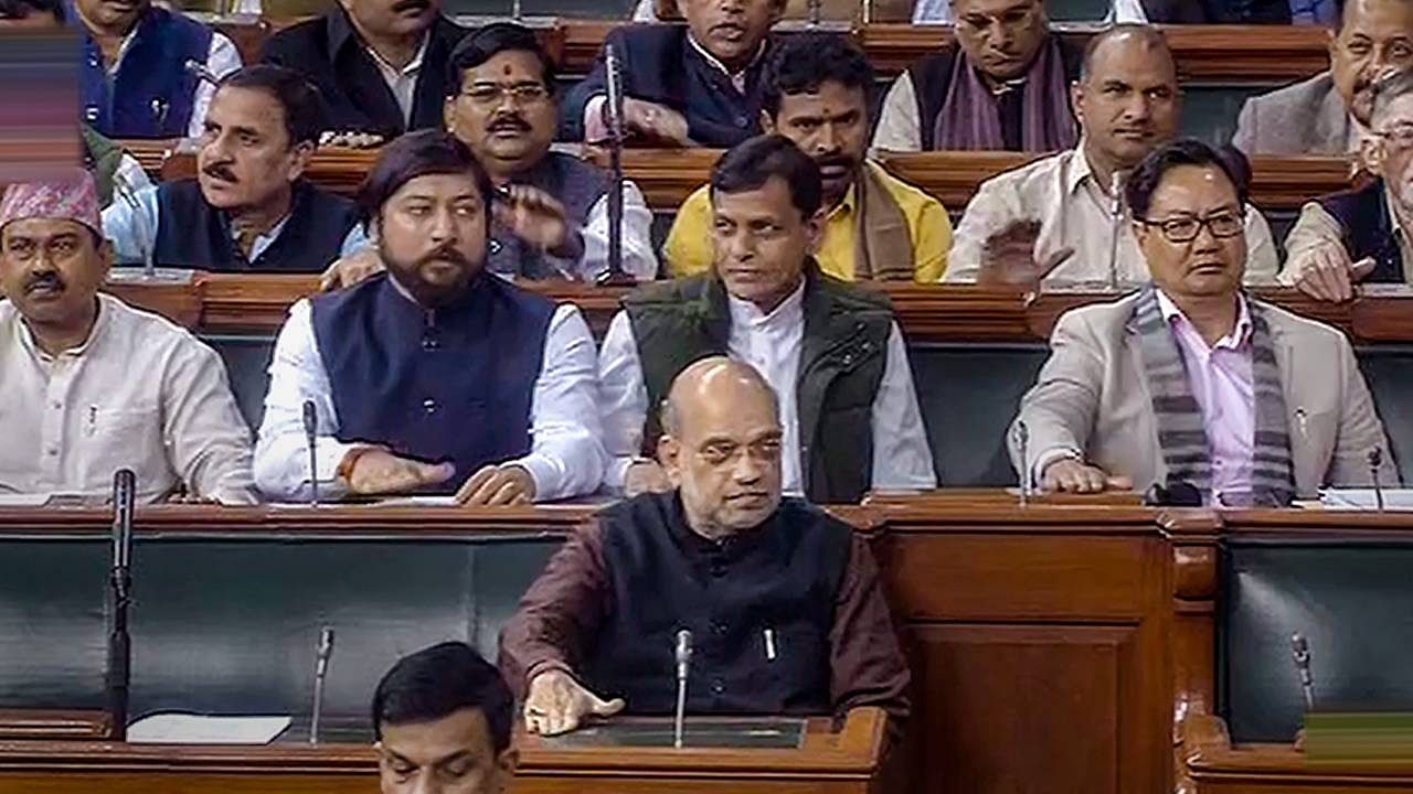 Home Minister Amit Shah, Union Law Minister Kiren Rijiju, Union MoS for Home Affairs Nityanand Rai, Union MoS for Sports Nisith Pramanik and other MPs in the Lok Sabha during the Winter Session of Parliament. Credit: PTI Photo
