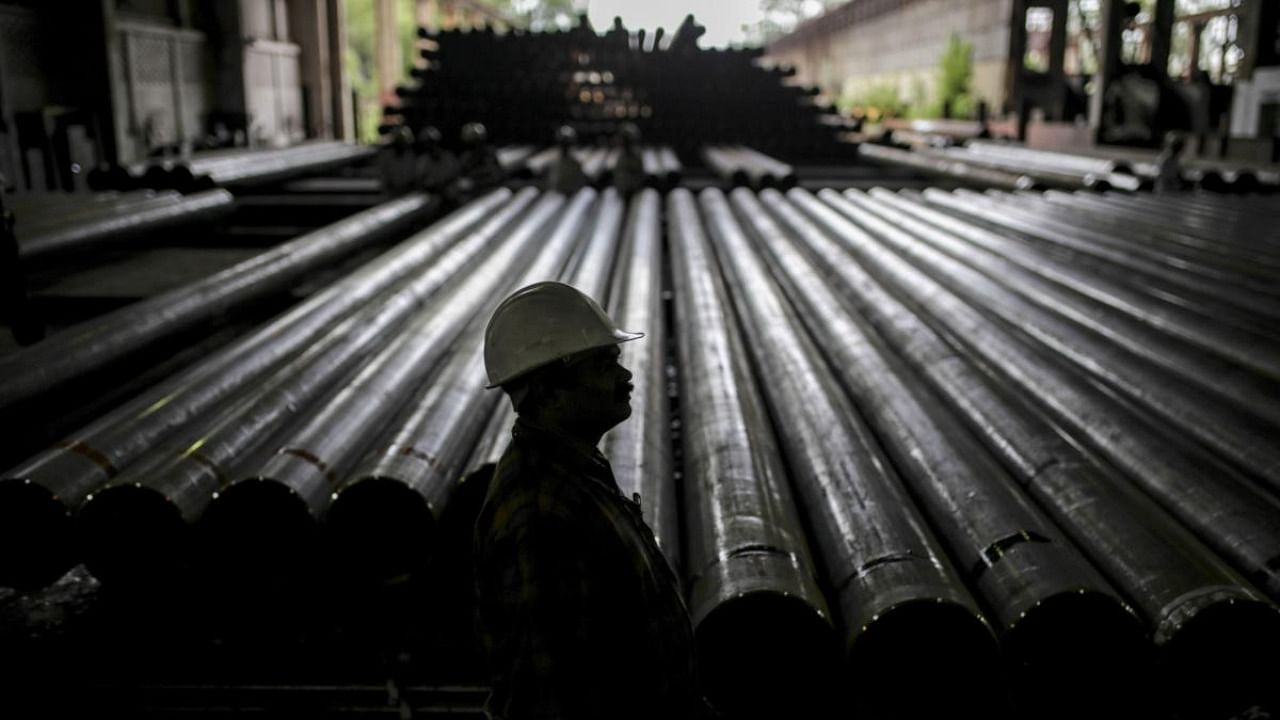 A worker stands in front of steel tubes at the finishing line of the steel tube mill at the Steel Authority of India Ltd. (SAIL) Rourkela Steel Plant (RSP) in Rourkela district, Odisha, India, on Friday, June 21, 2019. Credit: Bloomberg Photo
