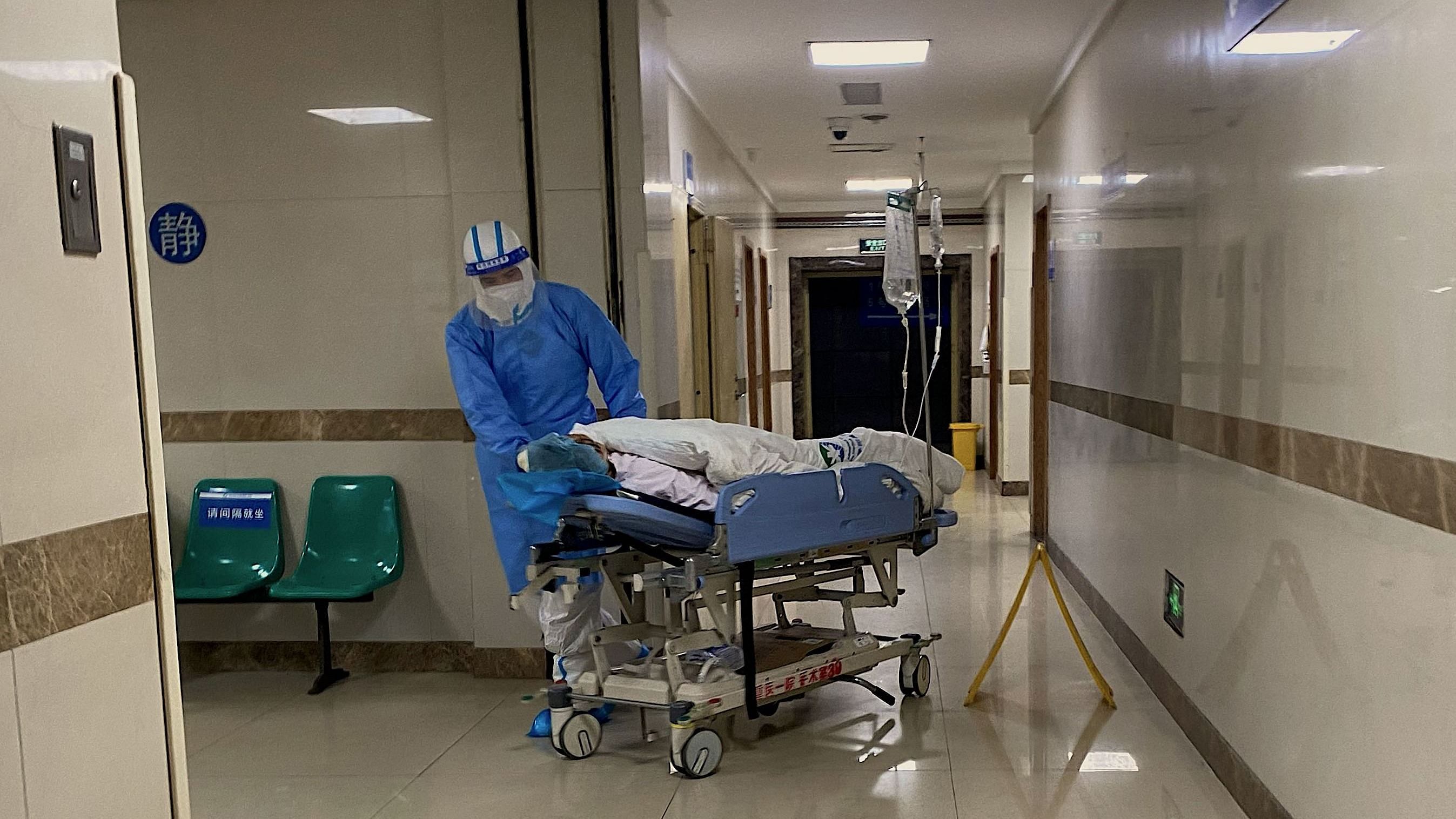This picture shows a Covid-19 patient on a stretcher in the emergency ward of the First Affiliated Hospital of Chongqing Medical University. Credit: AFP Photo