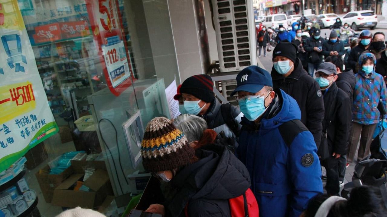 People queue to buy medicine at a pharmacy amid the Covid-19 pandemic in Nanjing, in China's eastern Jiangsu province on December 20, 2022. Credit: AFP Photo