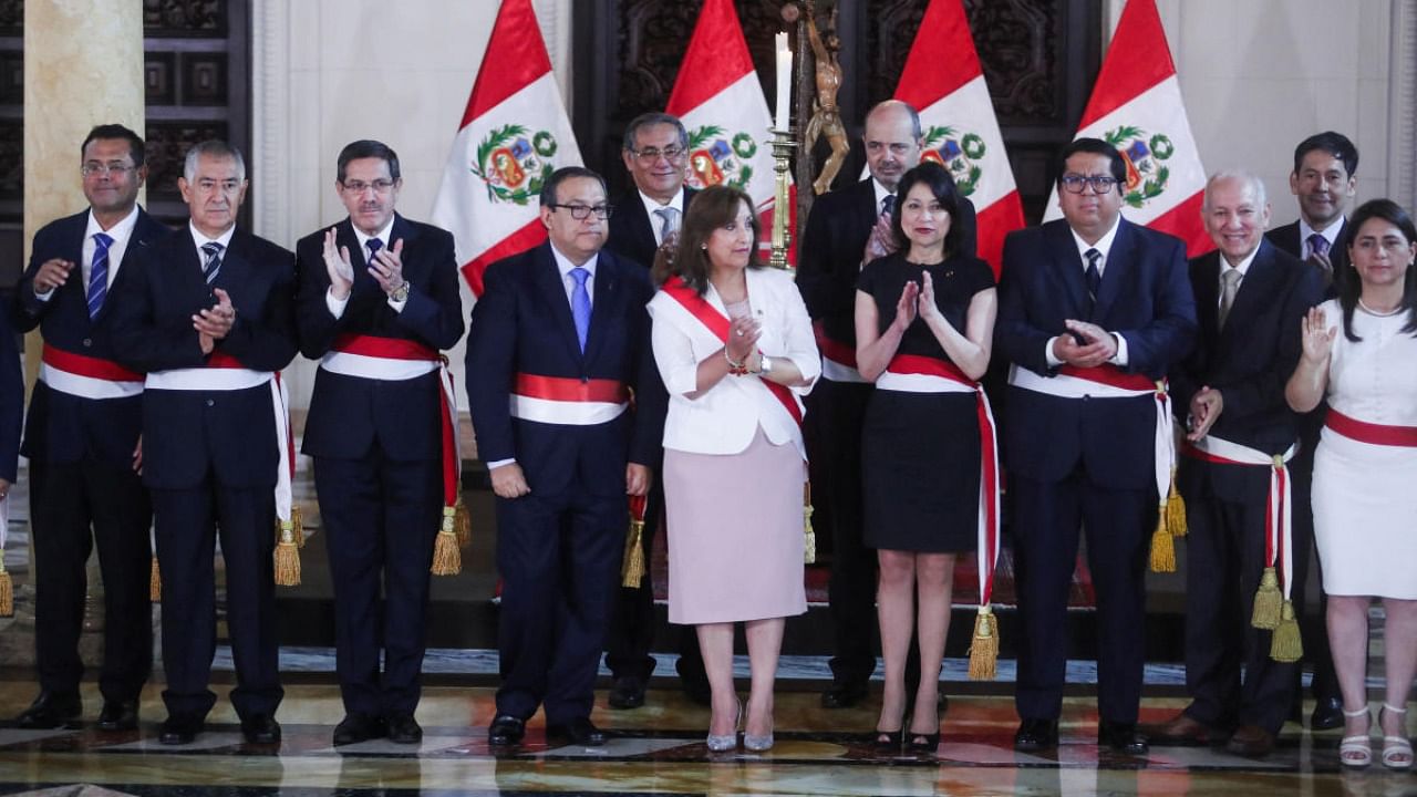Peru's President Dina Boluarte, who took office after her predecessor Pedro Castillo was ousted, claps alongside members of her new Cabinet, in Lima. Credit: Reuters photo