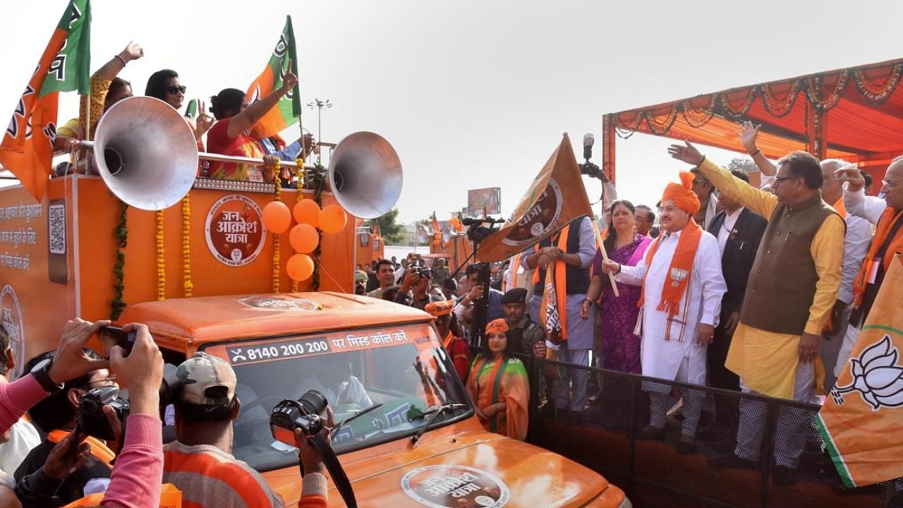 File photo of BJP's J P Nadda and Vasundhara Raje at the flagging off the party's Jan Aakrosh Yatra. Credit: PTI