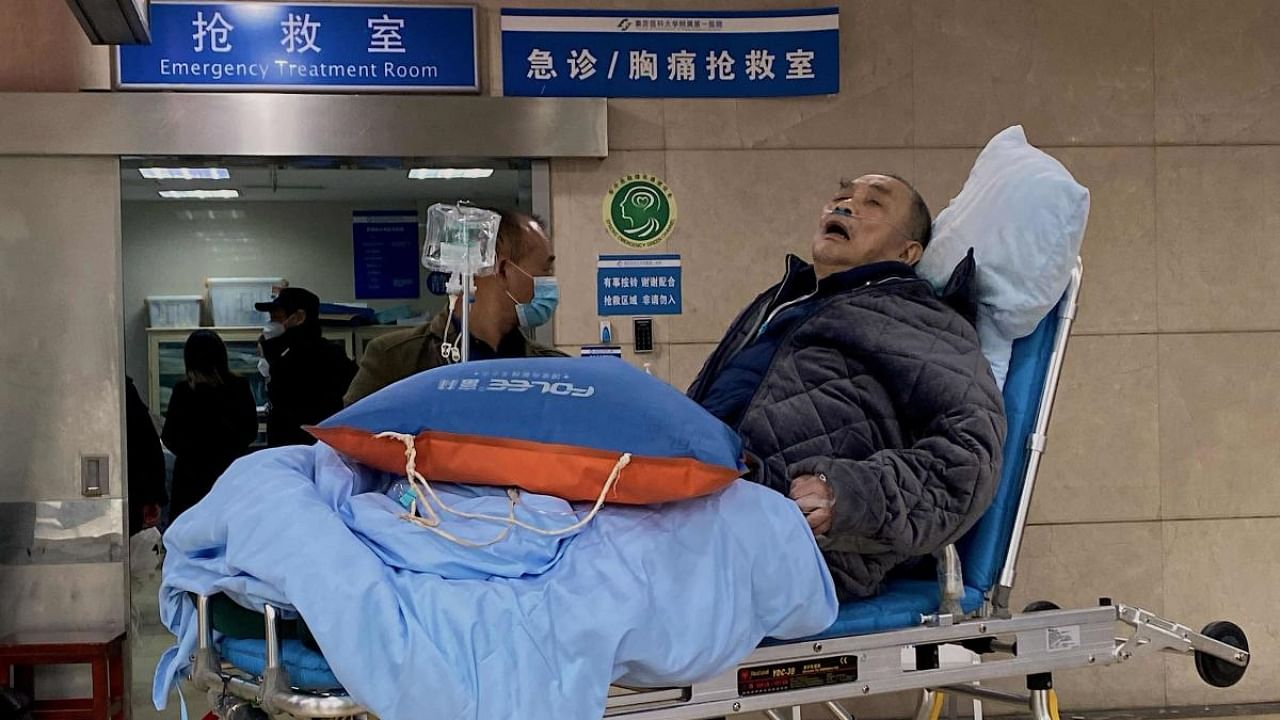 An elderly Covid-19 patient lies on a stretcher at the emergency ward of the First Affiliated Hospital of Chongqing Medical University in China's southwestern city of Chongqing. Credit: AFP Photo