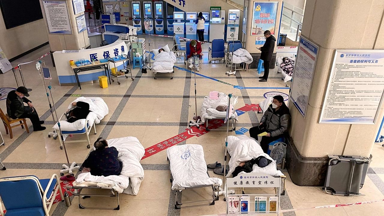 Covid-19 coronavirus patients lie on hospital beds in the lobby of the Chongqing No. 5 People's Hospital in China's southwestern city of Chongqing on December 23, 2022. Credit: AFP Photo