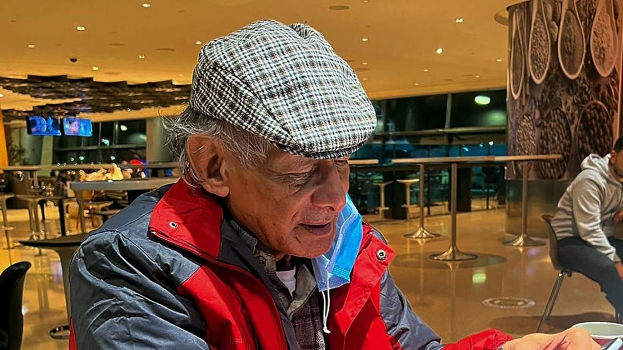 French serial killer Charles Sobhraj looks at his mobile phone in transit at Doha airport to France. Credit: AFP Photo