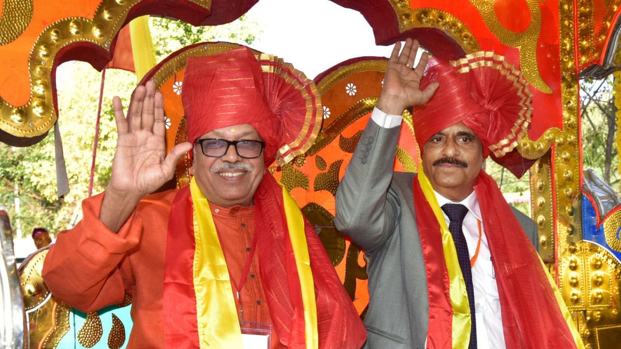 Writer H S Venkatesh Murthy, president of the 85th Kannada Sahitya Sammelana is brought in a procession with the then Kannada Sahitya Parishat president Manu Baligar to the Sammelana venue in Kalaburagi in February 2020. The 86th edition is set to be held in the central Karnataka city of Haveri from January 6-8, with Doddarangegowda as the meet president. Credit: DH file photo