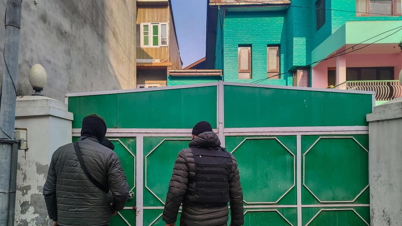 Police personnel at the gate of late Hurriyat Chairman Syed Ali Shah Geelani’s residential structures constructed over 17 Marlas of proprietary land at Barzulla, in Srinagar. Credit: PTI Photo