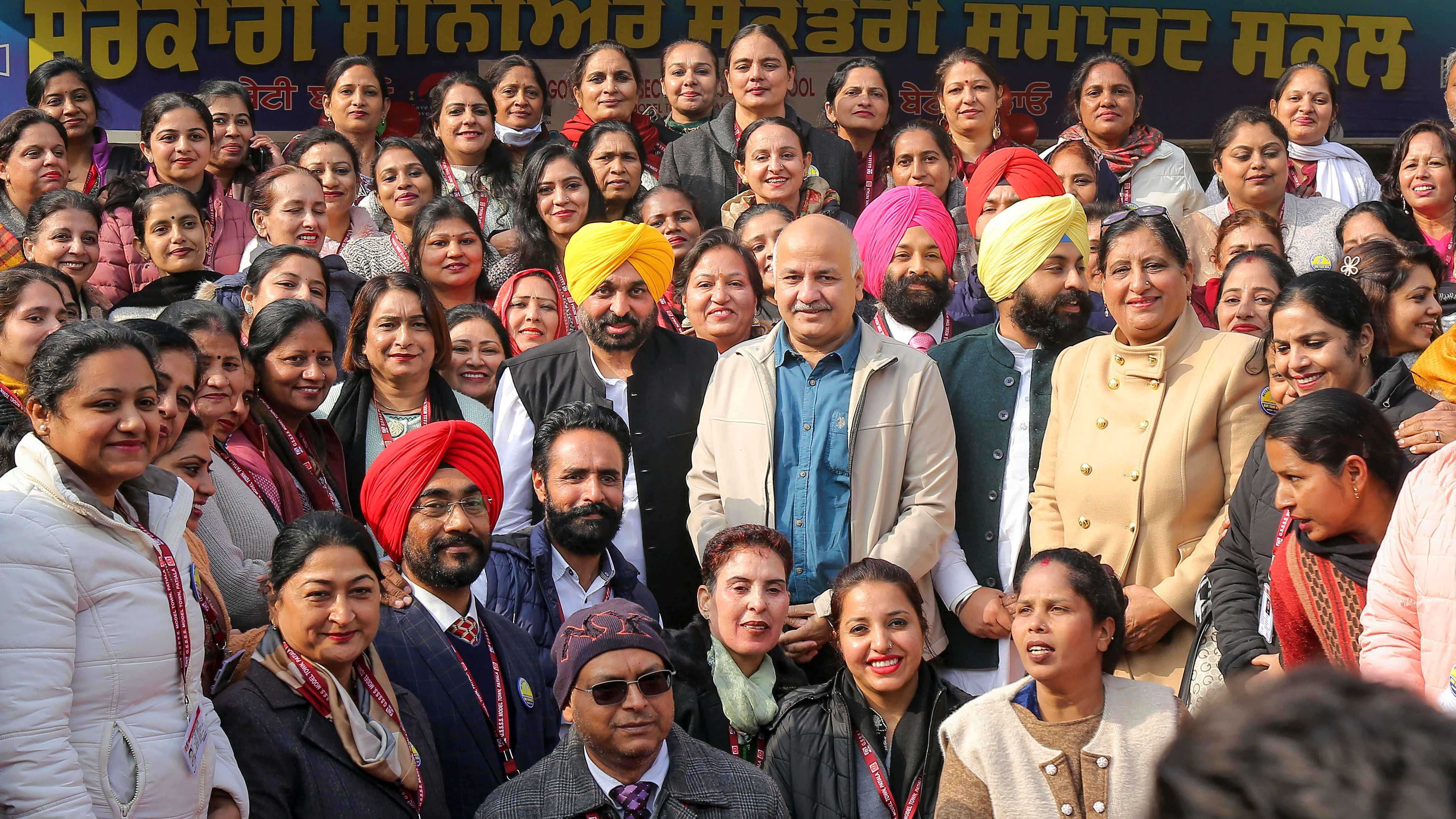 Bhagwant Mann along with Manish Sisodia poses for a group photo during the Parent-Teacher Meeting. Credit: PTI Photo
