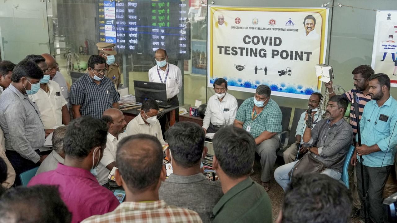 Tamil Nadu Minister for Medical and Family Welfare Ma Subramanian inspects passengers undergoing for Covid-19 test, at the Chennai International airport. Credit: PTI Photo