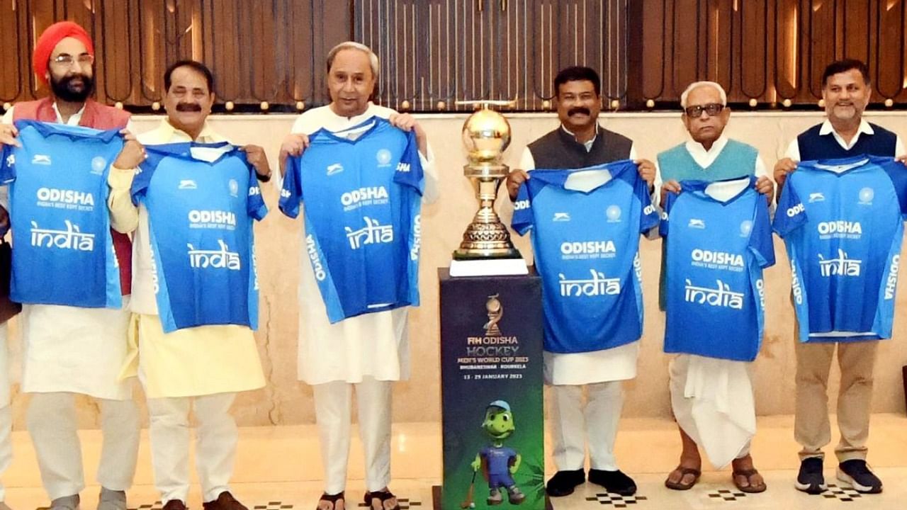 Odisha CM Naveen Patnaik with Union Education Minister Dharmendra Pradhan and other political leaders pose with Odisha Men’s Hockey World Cup trophy. Credit: PTI 
