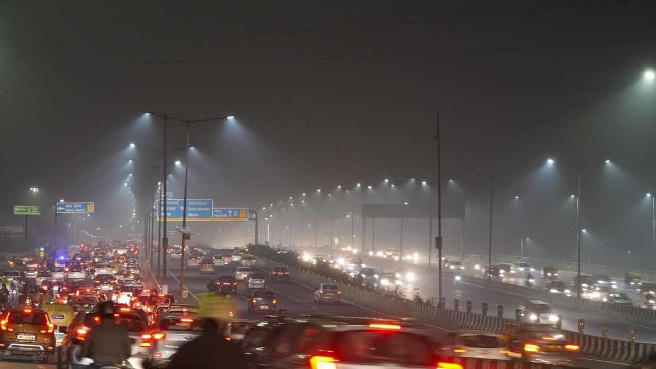 Fog covers the city on a winter evening, in New Delhi. Credit: PTI Photo