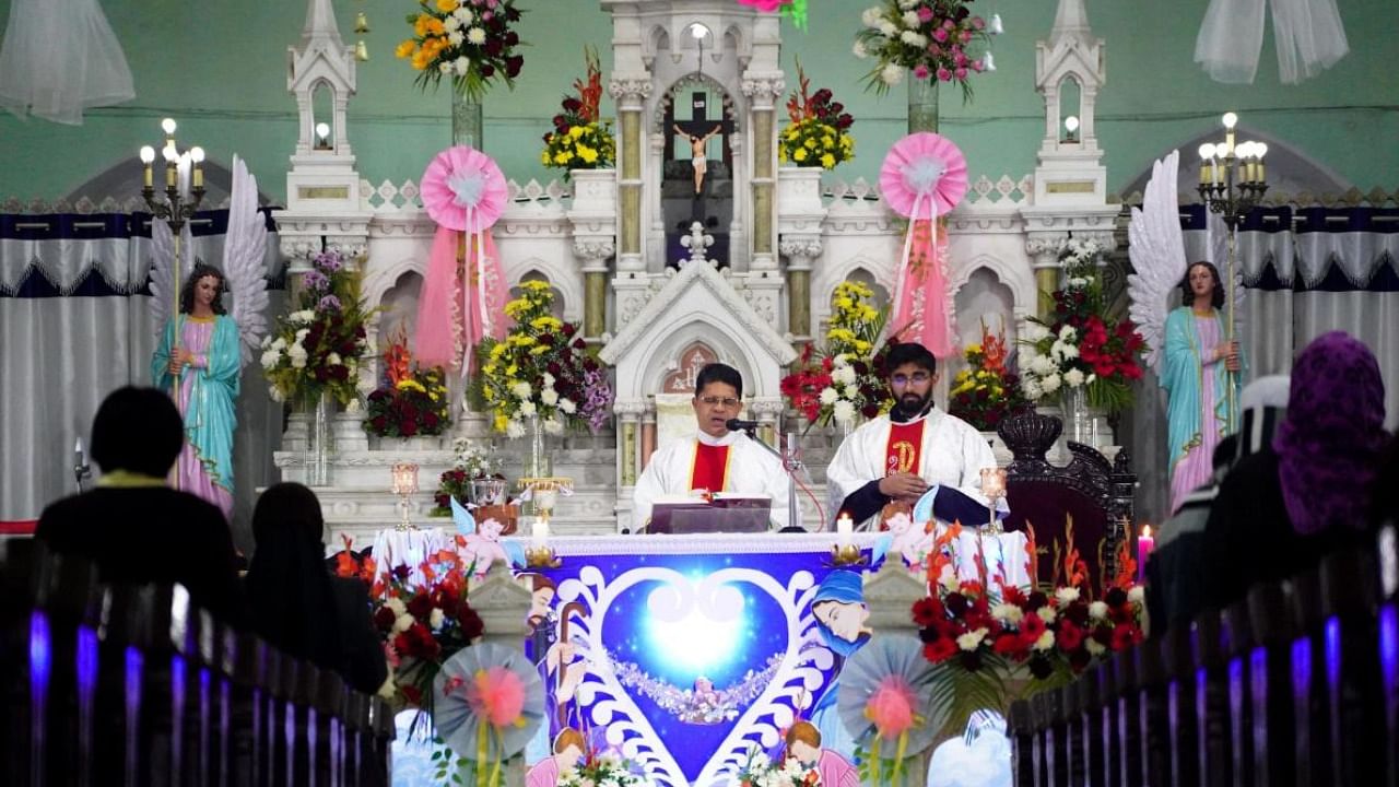 Devotees attend a special prayer on the occasion of Christmas at a church. Credit: PTI Photo