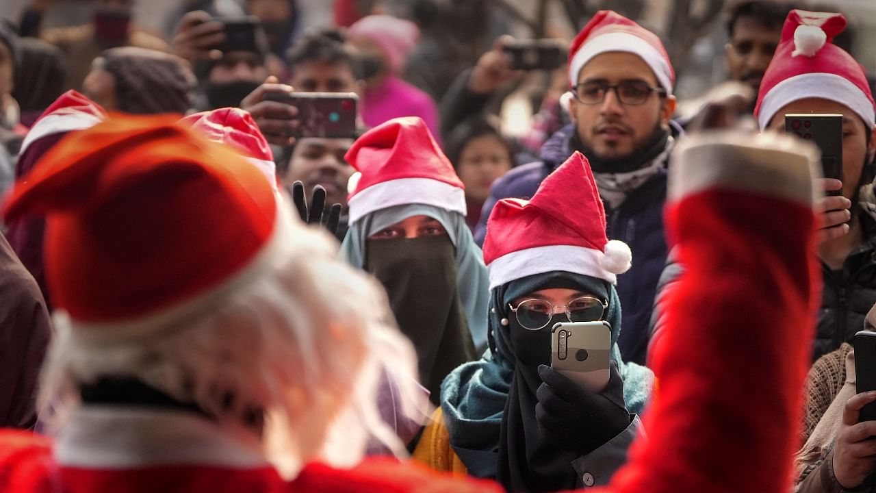 A group of Muslim men and women participates in Christmas celebrations at the Holy Family Catholic Church, in Srinagar. Credit: PTI Photo