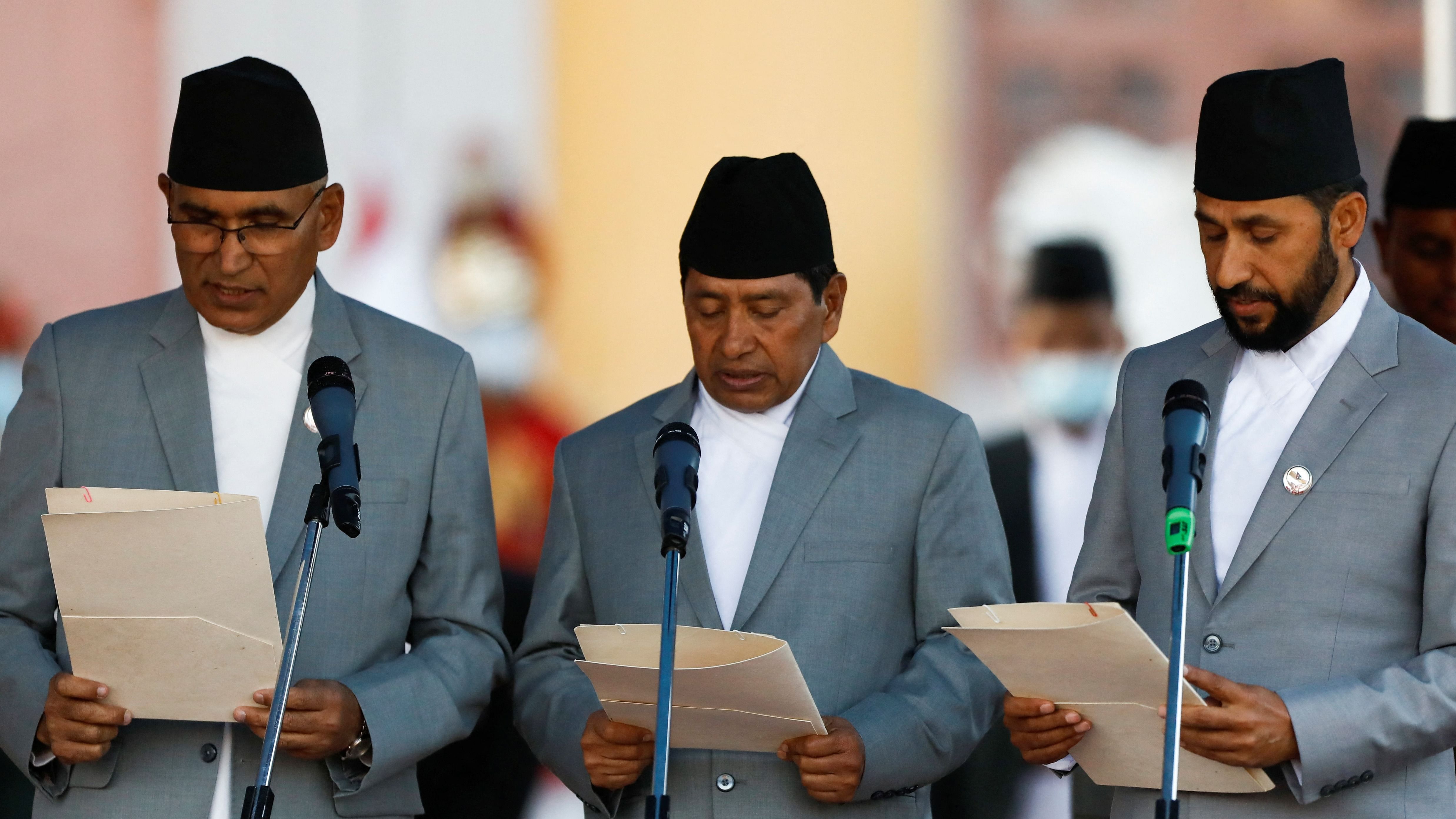 Bishnu Prasad Paudel (L), Deputy Prime Minister and Finance Minister along with Narayan Kaji Shrestha (C), Deputy Prime Minister and Minister of Physical Infrastructure and Transport and Rabi Lamichhane (R), Deputy Prime Minister and Home Minister administer the oath of office at the presidential building "Shital Niwas" in Kathmandu, Nepal. Credit: Reuters Photo