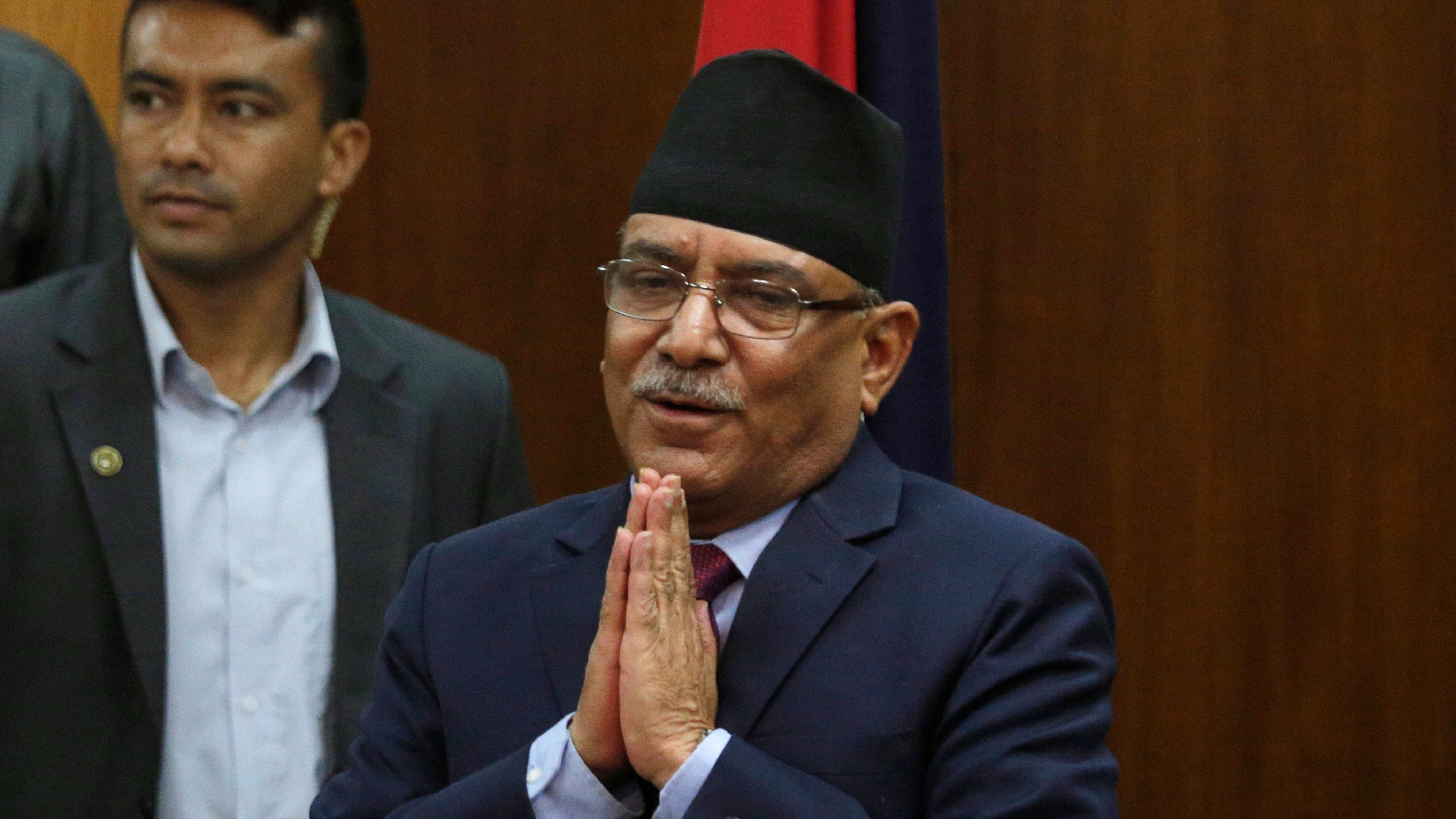 Leader of communist party Nepal, Pushpa Kamal Dahal greets the gathering after announcing his resignation as prime minister. Credit: AP Photo