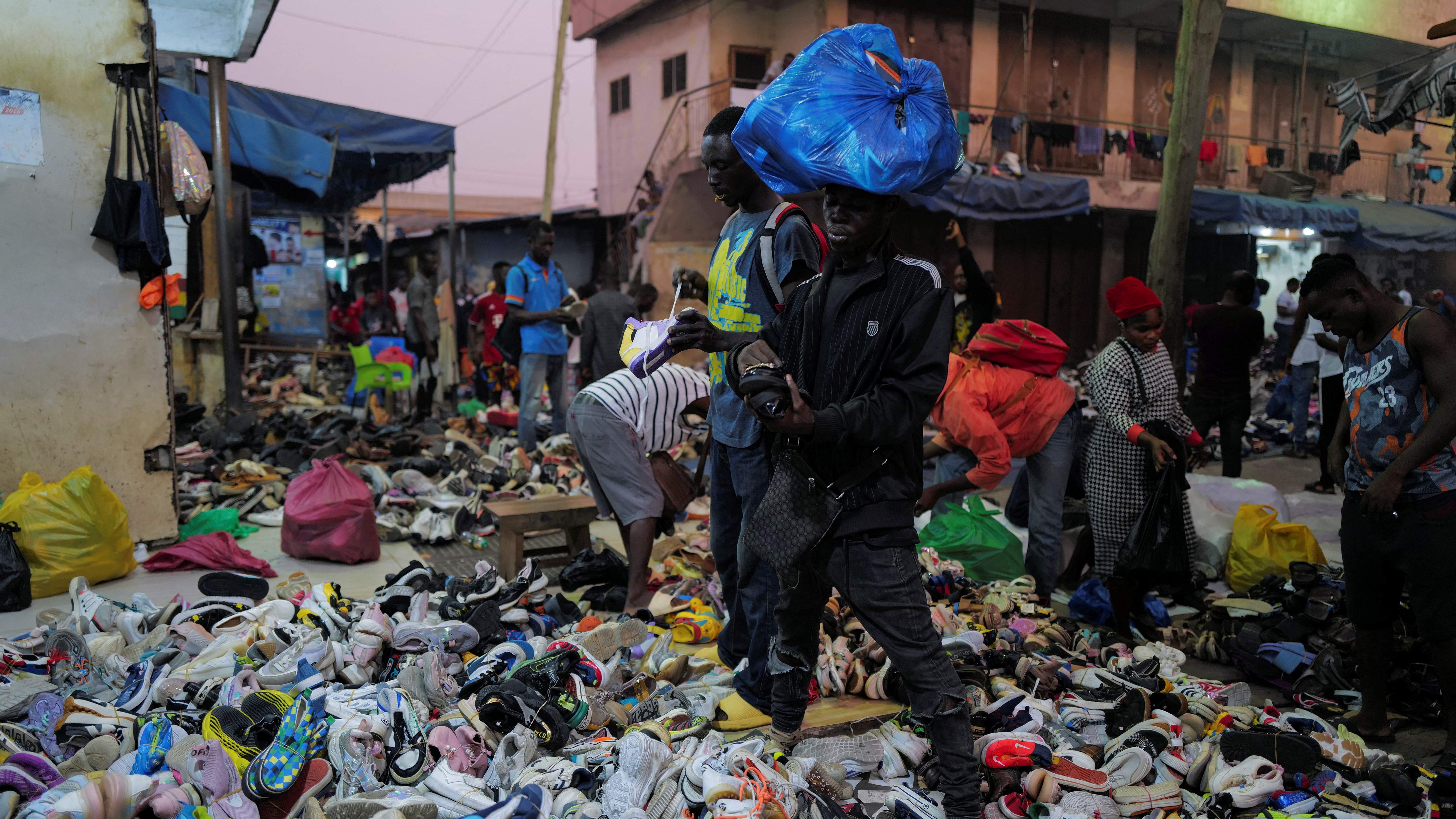 Shoppers buy second-hand shoes at the Kantamanto market in Accra, Ghana. Credit: Reuters File Photo