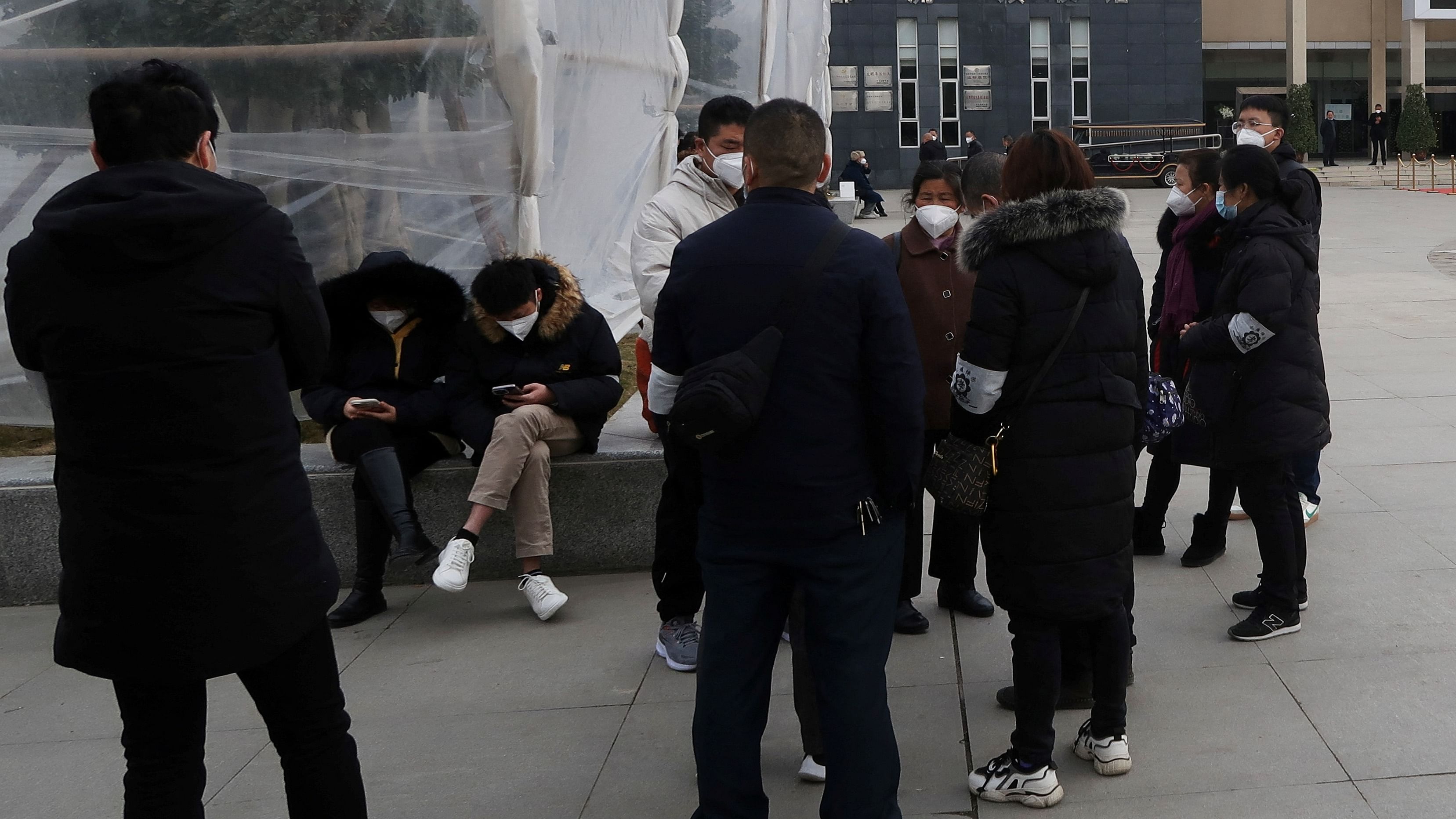 Relatives wait outside a funeral home, amid the coronavirus disease (COVID-19) outbreak in Chengdu, Sichuan province, China December 28, 2022.  Credit: Reuters Photo