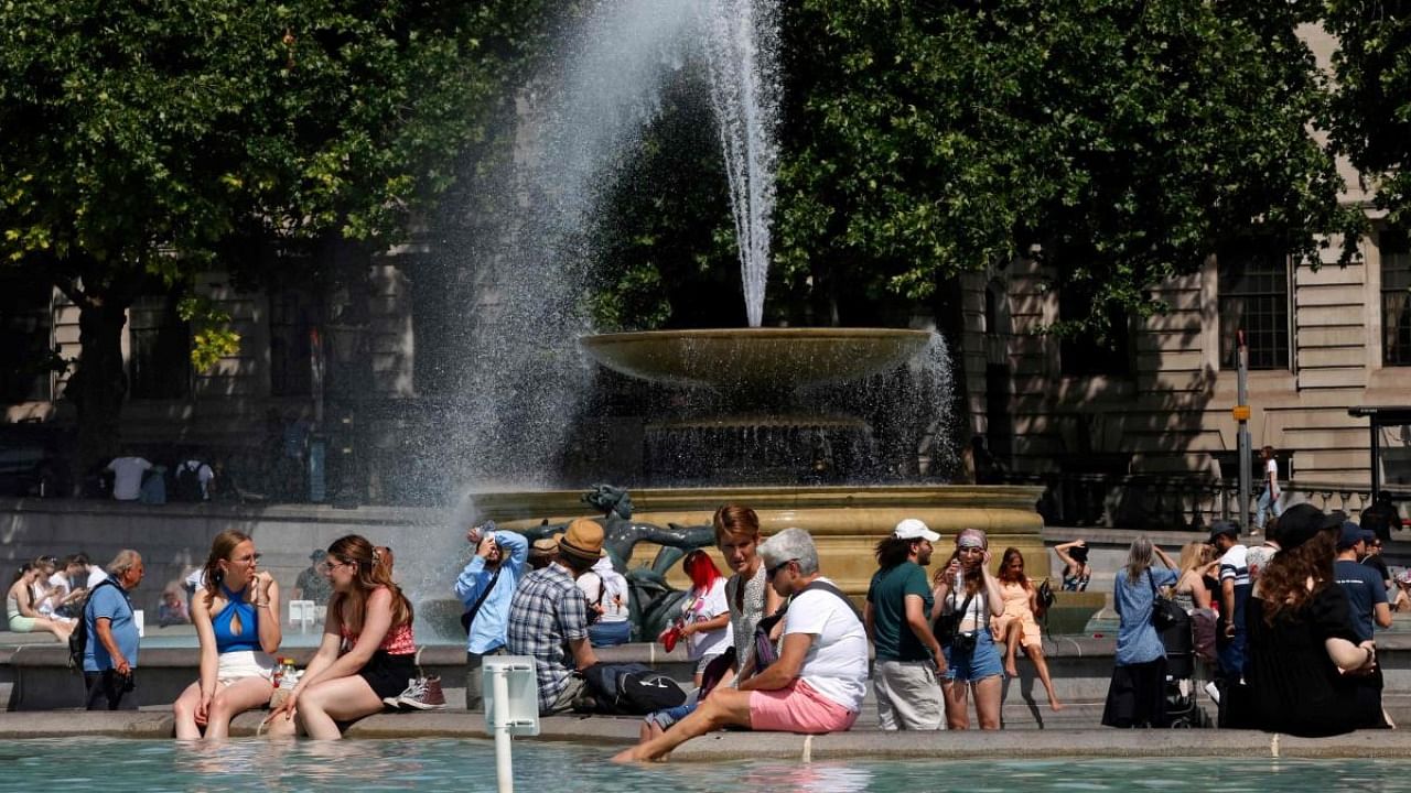 People cool off beside the fountains in Trafalgar Square in central London on June 17, 2022, on what is expected to be the hottest day of the year so far in the capital. Credit: AFP file photo