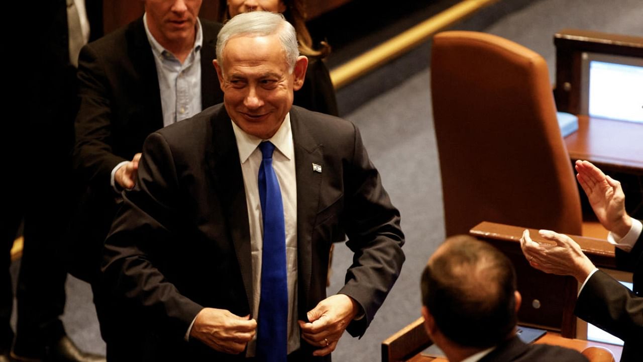 Israeli Prime Minister Benjamin Netanyahu adjusts his jacket as Israel's new right-wing government is sworn in at the Knesset, Israel's parliament in Jerusalem. Credit: Reuters photo