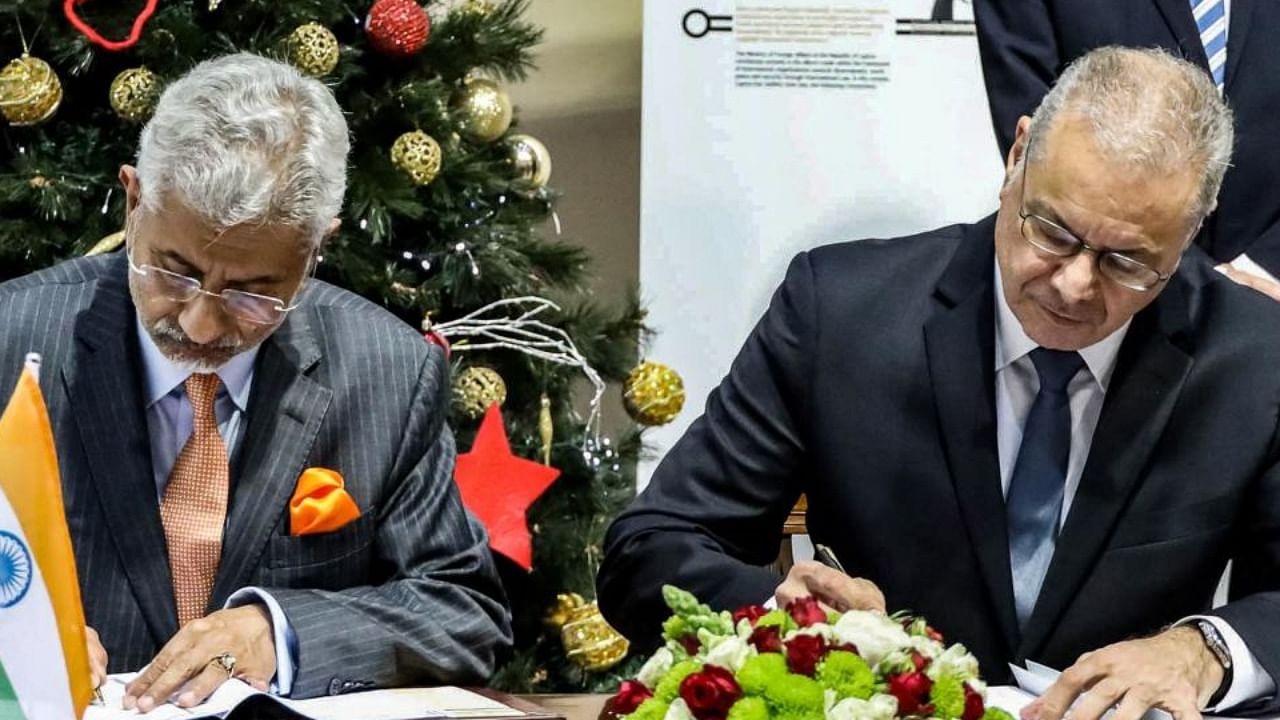 A handout picture provided by the Cypriot government's Press and Information Office (PIO) on shows (R to L) Cyprus' Interior Minister Nicos Nouris signing a declaration of intent on migration and mobility with India's Foreign Minister Subrahmanyam Jaishankar in the capital Nicosia on December 29, 2022. Credit: AFP Photo / HO / PIO