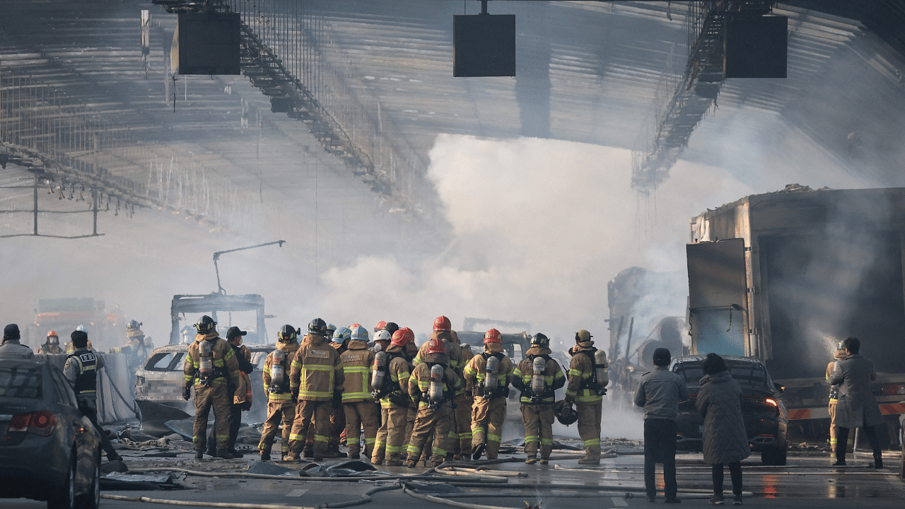 Firefighters work at the scene of a fire in an expressway tunnel in Gwacheon. Credit: AFP Photo
