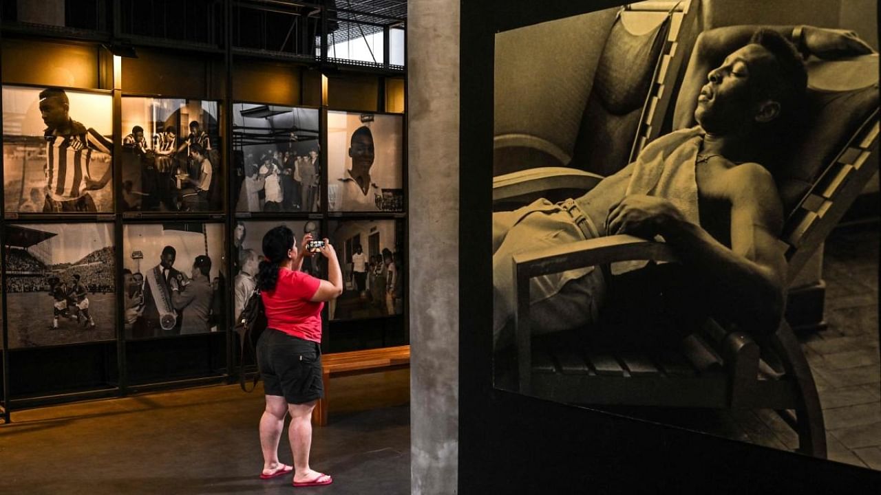 A visitor takes a picture at the Pele Museum, in Santos, Brazil, on December 27, 2022. Credit: AFP Photo