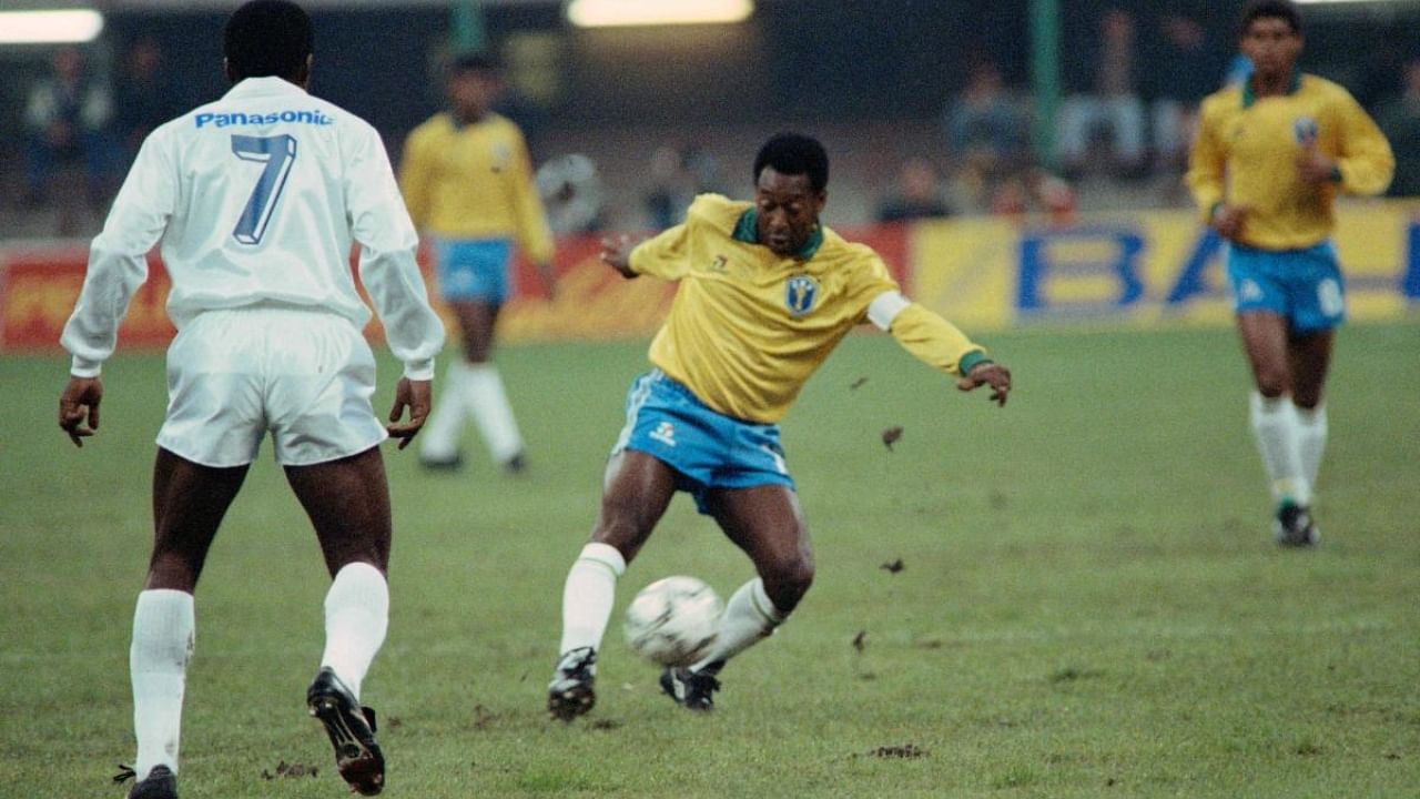  In this file photo taken on October 31, 1990 Former Brazilian soccer star, Edson Arantes do Nascimento, known as Pelé (L), plays the ball during a friendly soccer match opposing Brazil to world soccer star to celebrate Pele's fiftieth birthday in Milan. Credit: AFP Photo