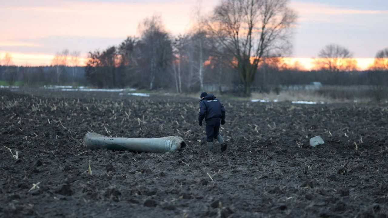 An investigator walks near a fragment of a munition, what Belarus' defence ministry said was part of a Ukrainian S-300 missile downed by Belarusian air defences near the village of Harbacha in the Grodno region, Belarus, December 29, 2022. Credit: Reuters Photo
