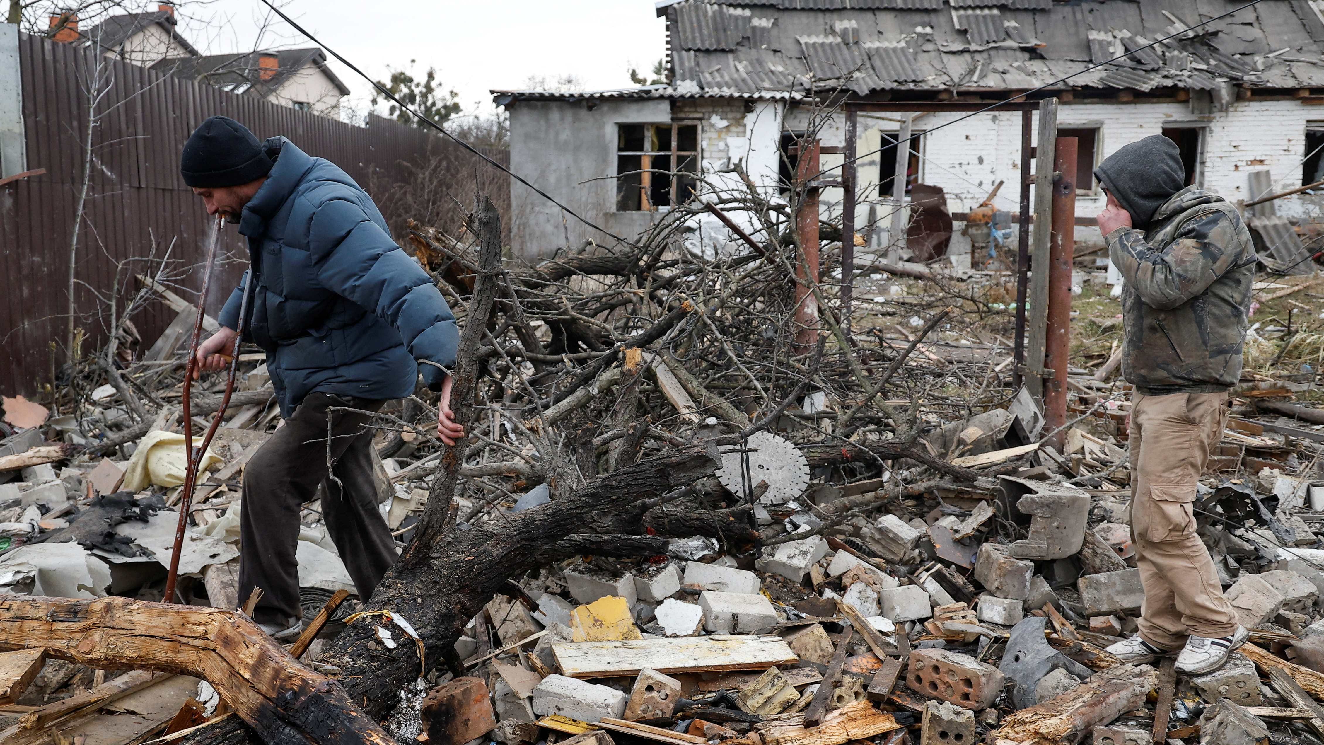 Local men walk at a site of a residential houses damaged during a Russian missile strike, amid Russia's attack on Ukraine, in Kyiv, Ukraine December 29. Credit: Reuters Photo