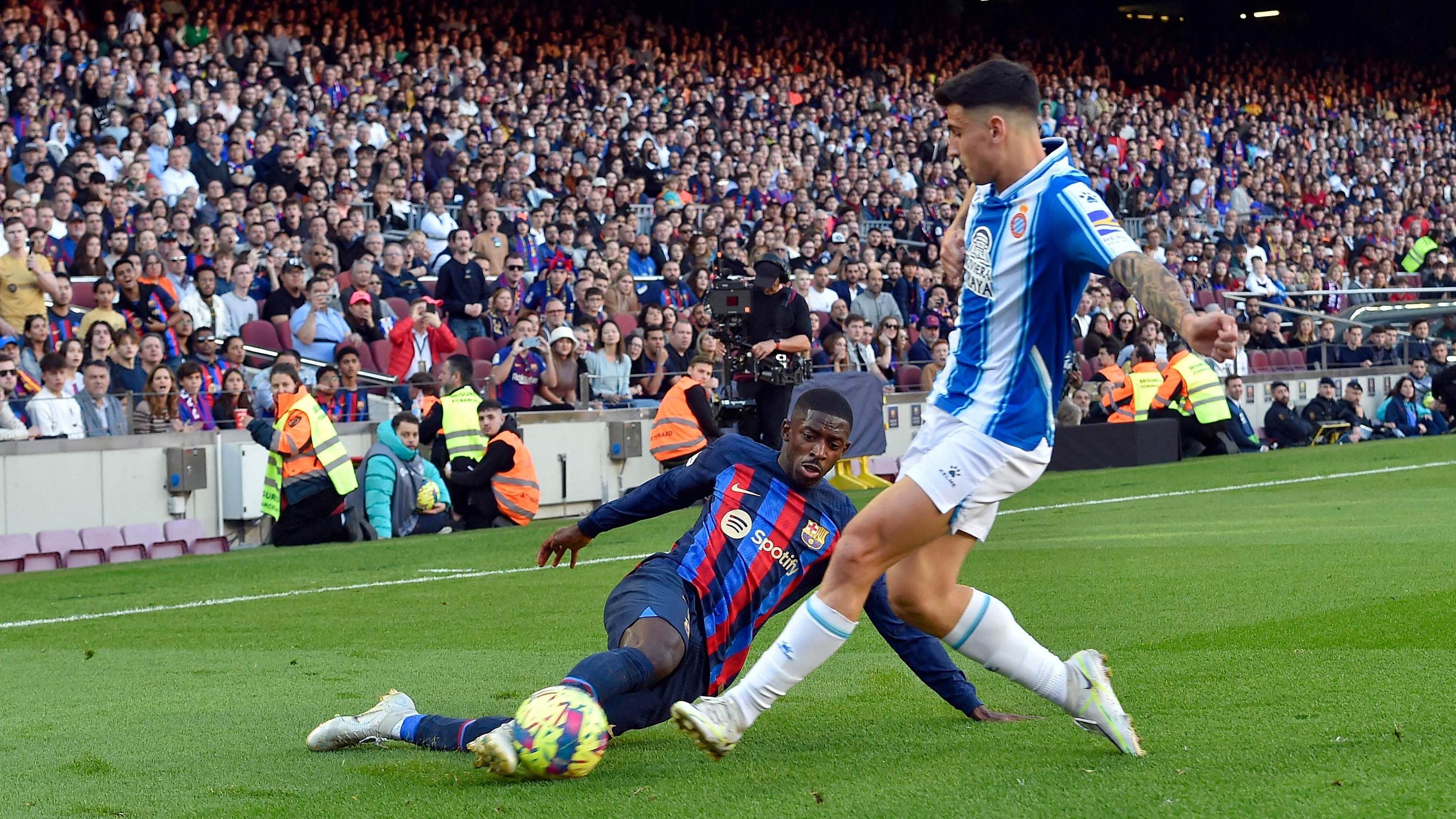 Barcelona's French forward Ousmane Dembele (L) tackles Espanyol's Spanish defender Ruben Sanchez during the Spanish League football match. Credit: AFP Photo