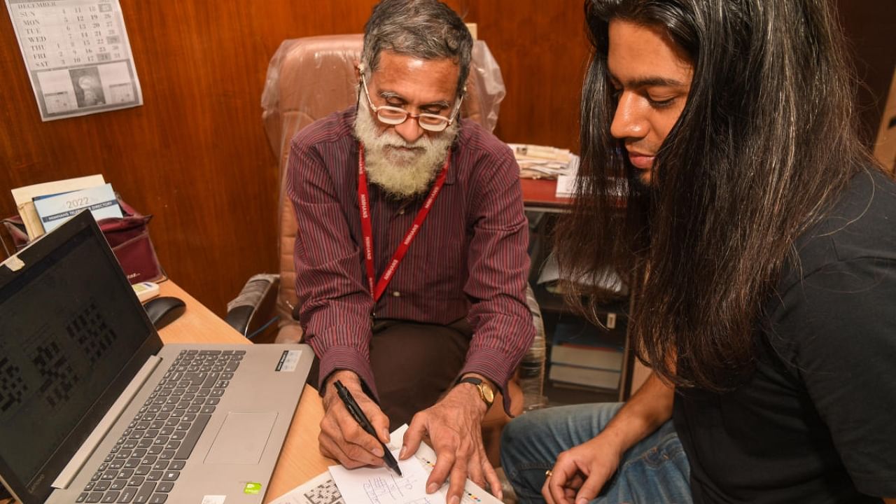 DH's Anand Singh with Dr Chittaranjan Andrade, a Professor in the Department of Psychopharmacology at NIMHANS, who has a hobby of setting crossword puzzles, in Bengaluru on Monday. Credit: DH Photo/ B H Shivakumar