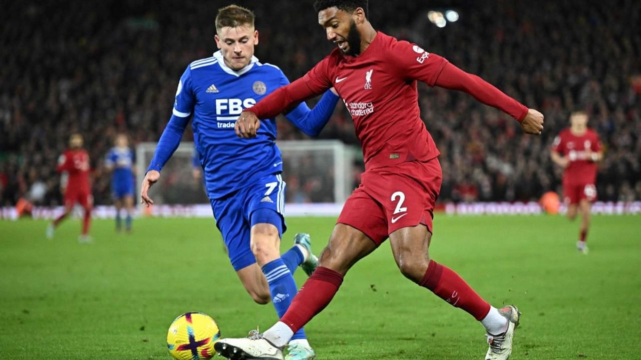 Leicester City's English midfielder Harvey Barnes (L) fights for the ball with Liverpool's English defender Joe Gomez during the English Premier League football match between Liverpool and Leicester City at Anfield in Liverpool, north west England on December 30, 2022. Credit: AFP Photo