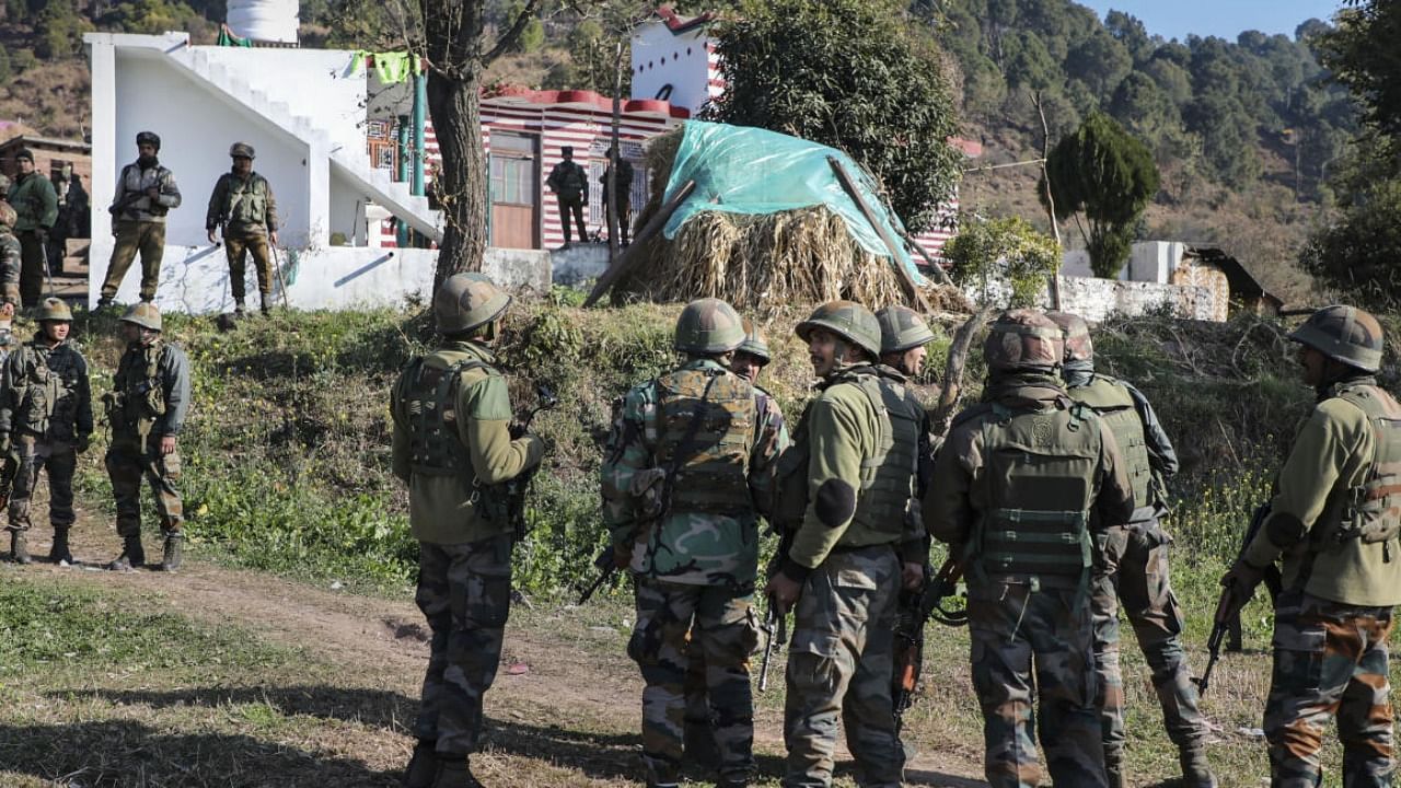 Army personnel stand near the house where an IED explosion took place, at Dangri village in Rajouri district. Credit: PTI Photo