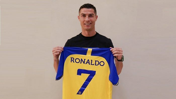 Ronaldo was pictured on the Al Nassr Twitter feed holding a blue and yellow shirt with his favoured number seven printed on the back. Credit: Twitter/@AlNassrFC_EN