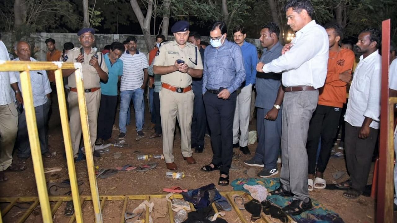 Police personnel investigate after three people were killed and several others suffered injuries due to a stampede at Telugu Desam Party's programme in Guntur. Credit: PTI Photo
