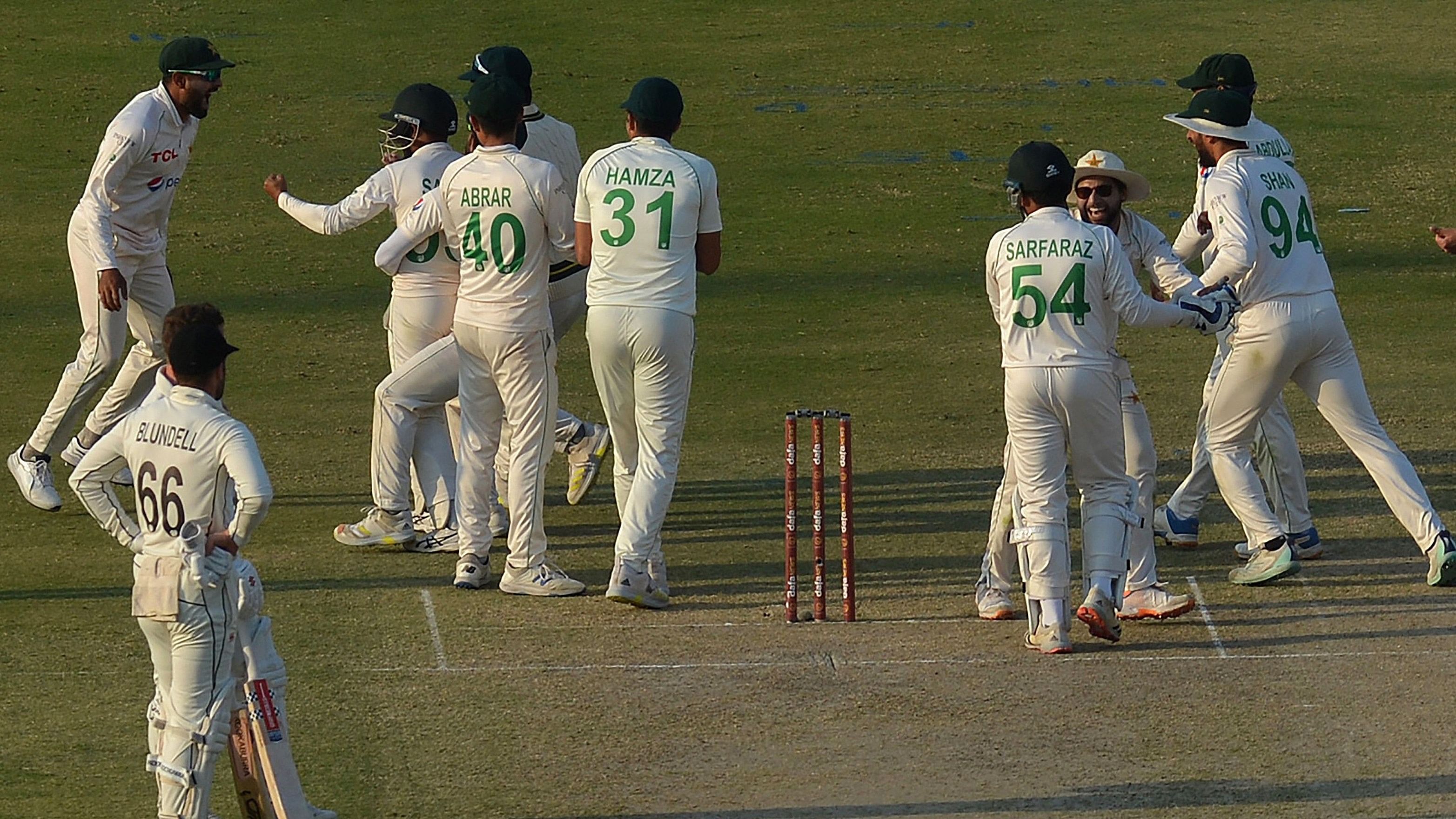 Pakistan's players celebrate after the dismissal of New Zealand's Henry Nicholls. Credit: AFP Photo