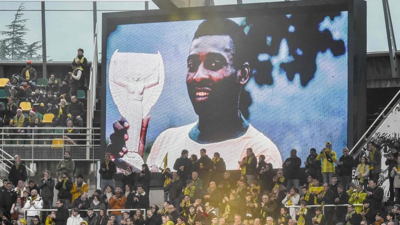 Supporters applause as they pay tribute to the recently deceased Brazilian professional football player Pele during the French L1 football match between FC Nantes and AJ Auxerre at the Stade de la Beaujoire – Louis Fonteneau in Nantes, western France on January 1, 2023. Credit: AFP Photo