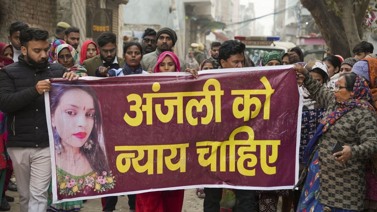 Family members along with locals protest demanding justice for the woman who was killed after being dragged by a car, at Karan Vihar area of Sultanpuri. Credit: PTI Photo