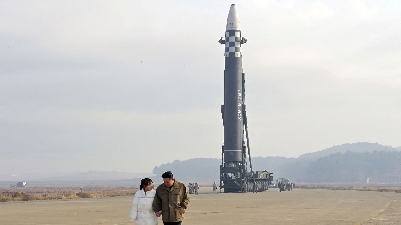 North Korean leader Kim Jong Un, along with his daughter, walks away from an intercontinental ballistic missile (ICBM) in this undated photo released on November 19, 2022. Credit: KCNA via Reuters