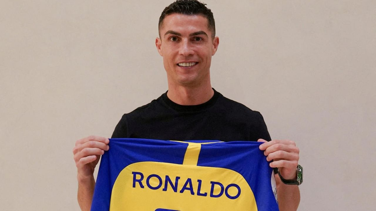 Cristiano Ronaldo holds a shirt of the Saudi Arabian club Al-Nassr after signing the contract that runs until 2025. Credit: Al-Nassr FC/handout via Reuters