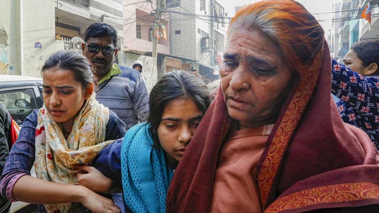 Anshika, sister of the 20-year-old woman Anjali Singh who was killed after being hit and dragged by a car, being taken away after she fainted during a visit by Deputy CM Manish Sisodia at her residence, at Sultanpuri in New Delhi, Wednesday, Jan. 4, 2023. Credit: PTI Photo