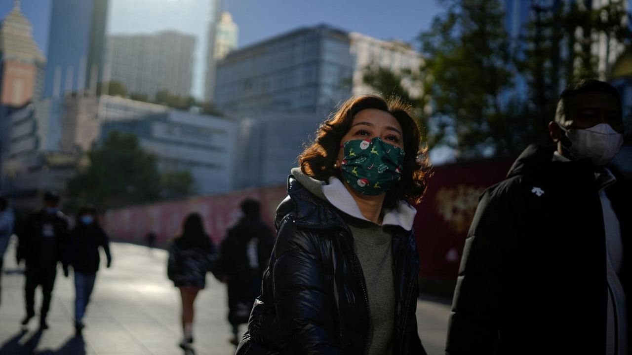 People wearing protective masks walk in a shopping district as China returns to work despite continuing coronavirus disease outbreaks in Shanghai, China, January 3, 2023. Credit: Reuters Photo