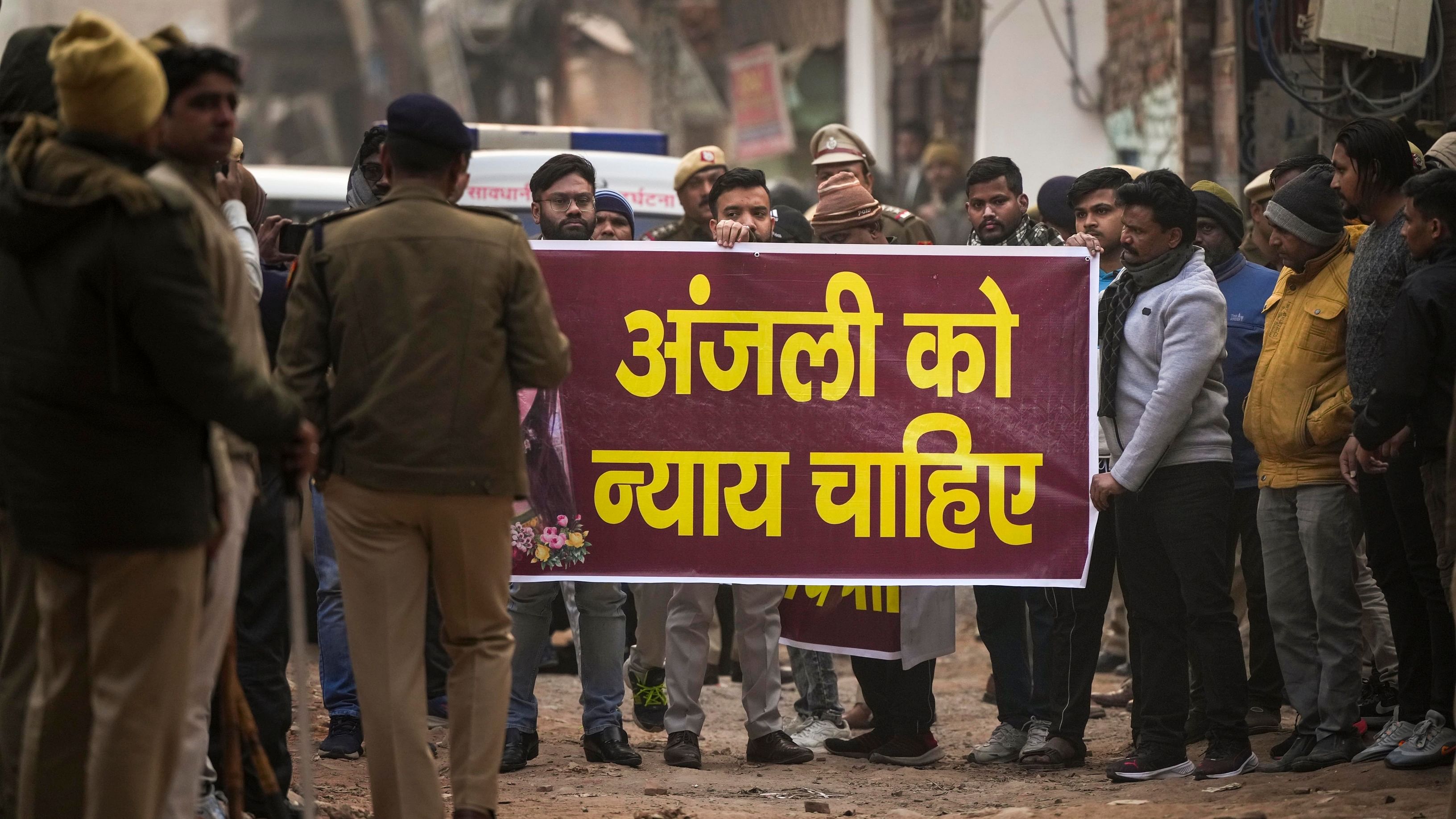 Locals protest demanding justice for the woman who was killed after being dragged by a car, at Karan Vihar area of Sultanpuri, in New Delhi, Tuesday, Jan. 3, 2023. Credit: PTI Photo