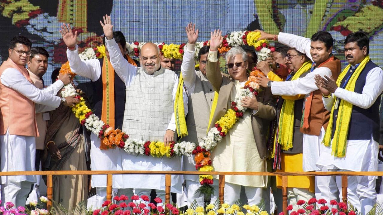 Union Home Minister Amit Shah Minister being garlanded during a Bharatiya Janata Party rally at Dhamanagar in poll-bound Tripura. Credit: PTI Photo