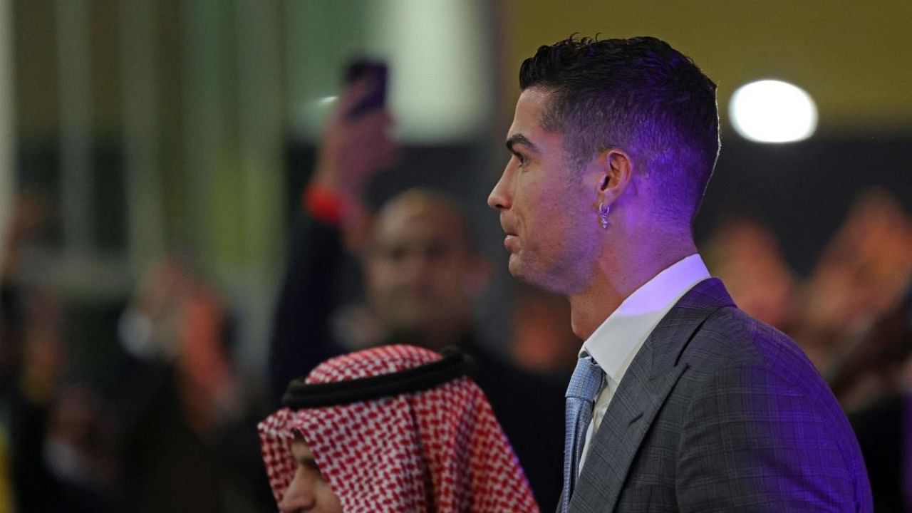 Portuguese forward Cristiano Ronaldo, wearing a cross earing, arrives at the Mrsool Park Stadium in the Saudi capital Riyadh on January 3, 2023 ahead of his unveiling as an Al-Nassr player. Credit: AFP Photo