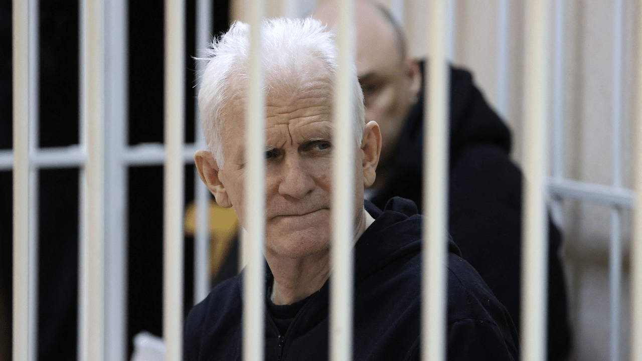Nobel Prize winner Ales Bialiatski is seen in the defendants' cage in the courtroom at the start of the hearing in Minsk. Credit: AFP Photo