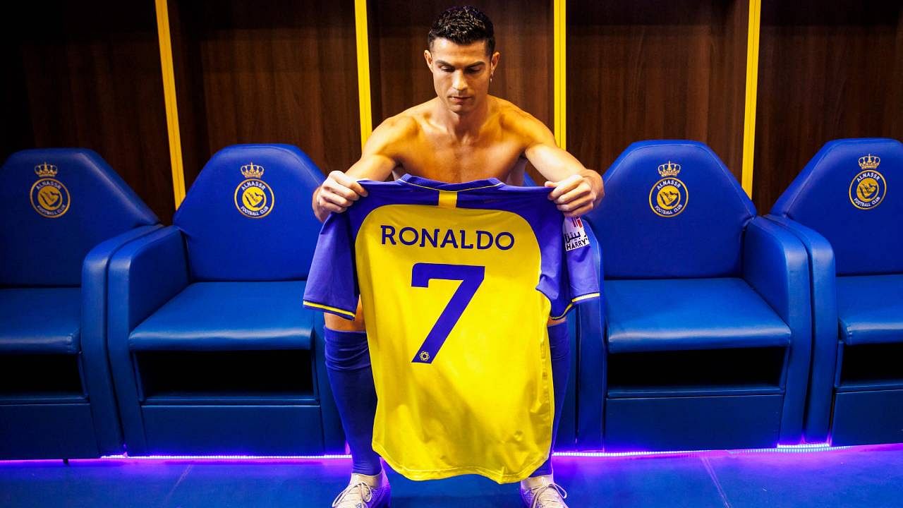 A handout picture released by Saudi Arabia's al-Nassr football club shows Al-Nassr's new forward Cristiano Ronaldo holding the club's number seven jersey ahead of his unveiling ceremony at the Mrsool Park Stadium in the Saudi capital Riyadh. Credit: AFP Photo