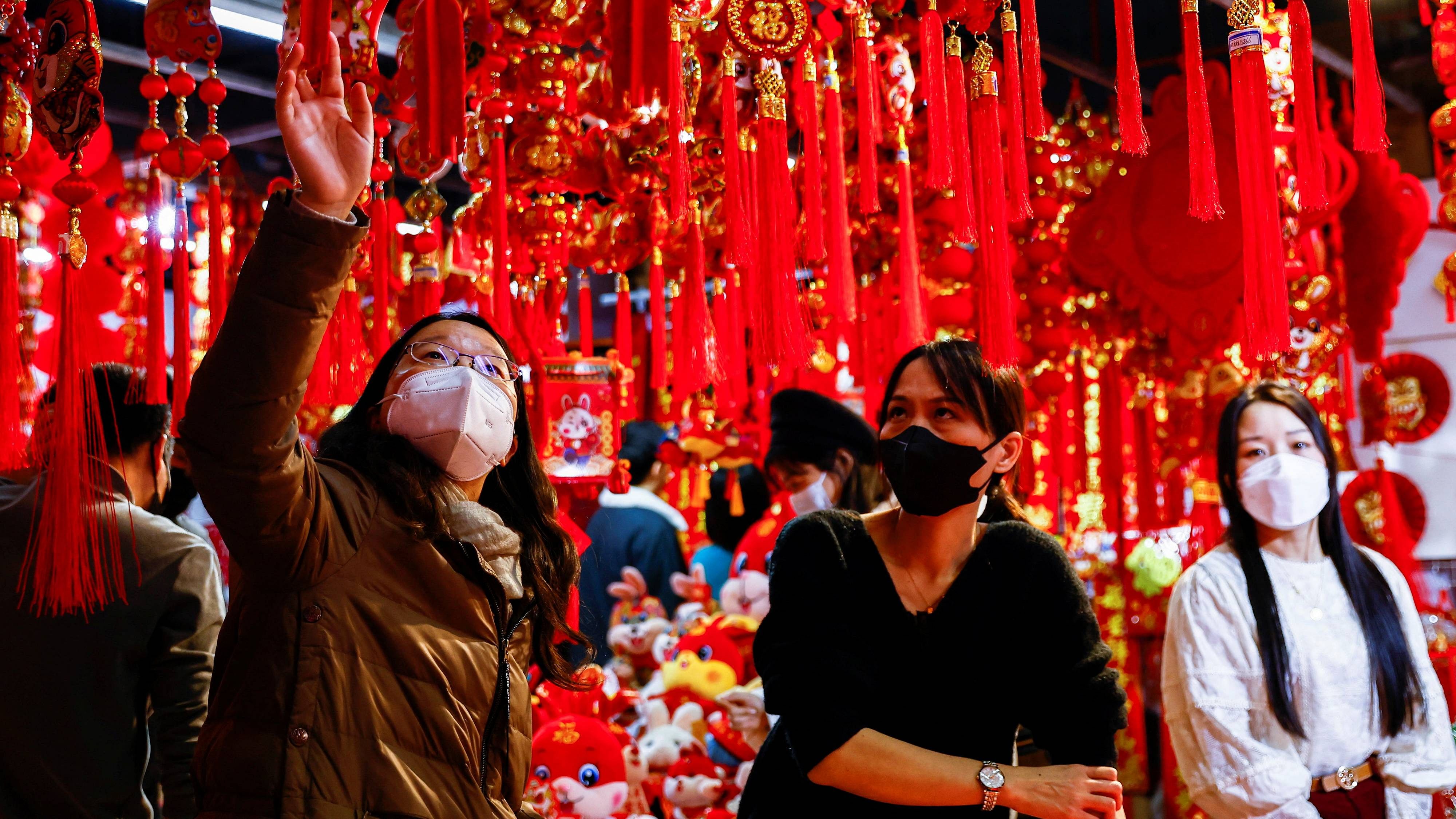 A customer looks at decorations for Chinese Lunar New Year at a market selling Spring Festival ornaments ahead of the Chinese Lunar New Year festivity, in Beijing, China. Credit: Reuters Photo